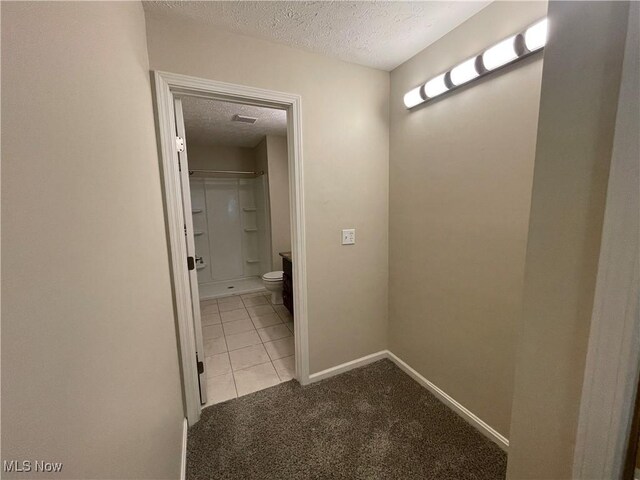 1304 Cedarwood Dr Unit D2, Westlake, OH 44145 - corridor featuring a textured ceiling, carpet floors, and tile patterned flooring