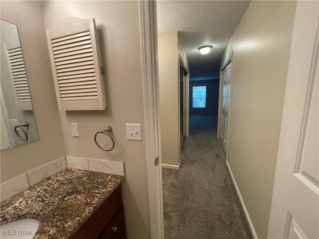 1304 Cedarwood Dr Unit D2, Westlake, OH 44145 - hallway featuring carpet and a textured ceiling