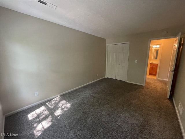 1304 Cedarwood Dr Unit D2, Westlake, OH 44145 - unfurnished bedroom with dark colored carpet, a closet, and a textured ceiling