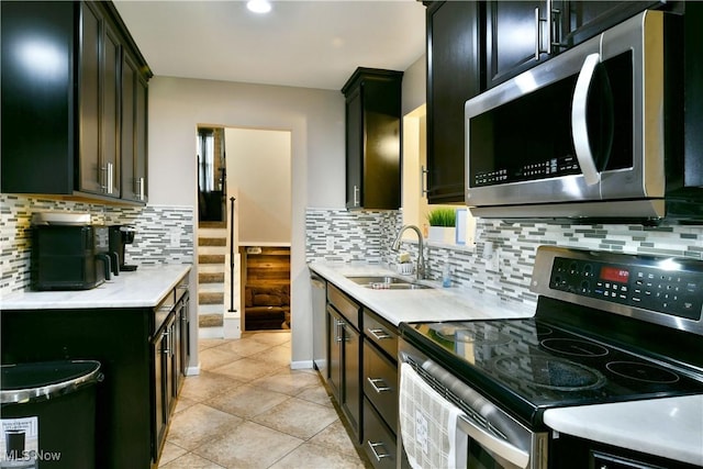 3992 Allenwood Dr SE, Warren, OH 44484 - kitchen featuring appliances with stainless steel finishes, light countertops, tasteful backsplash, light tile patterned floors, and recessed lighting