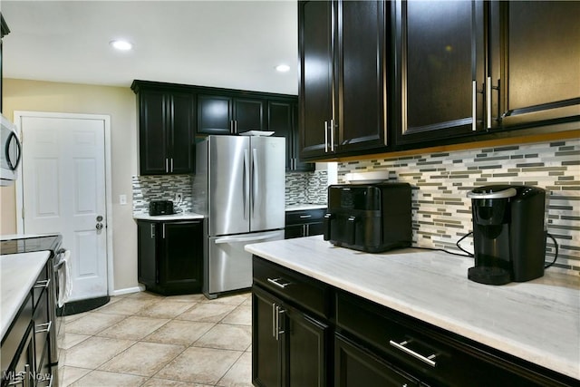 3992 Allenwood Dr SE, Warren, OH 44484 - kitchen featuring stainless steel appliances, light countertops, backsplash, light tile patterned floors, and recessed lighting