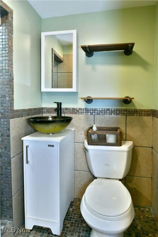 3992 Allenwood Dr SE, Warren, OH 44484 - bathroom with tile walls, vanity, and a wainscoted wall