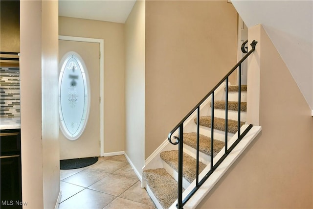 3992 Allenwood Dr SE, Warren, OH 44484 - tiled entryway with stairs and baseboards