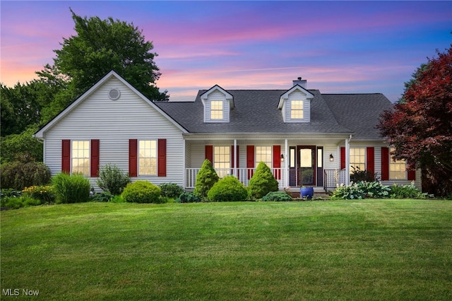 1550 Rebel St SW, Canton, OH 44706 - cape cod-style house with covered porch, a chimney, a front yard, and a shingled roof