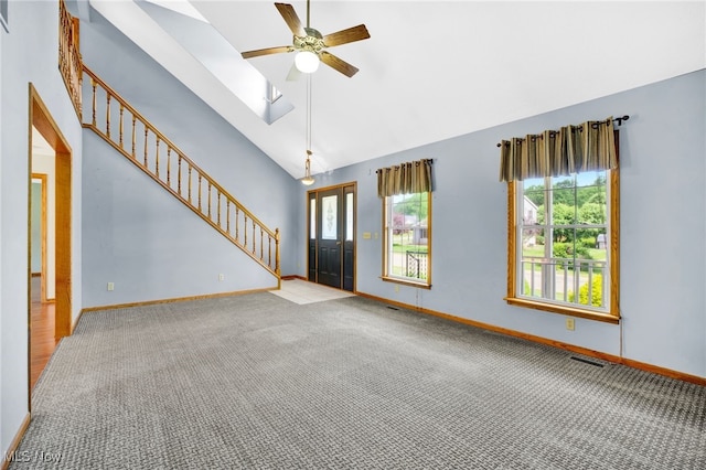 1550 Rebel St SW, Canton, OH 44706 - unfurnished living room with carpet, a ceiling fan, stairway, and high vaulted ceiling