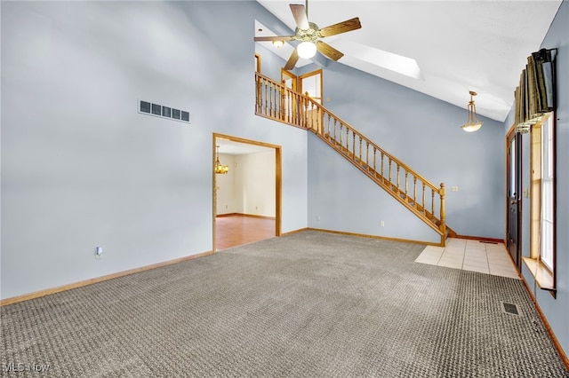 1550 Rebel St SW, Canton, OH 44706 - unfurnished living room with carpet flooring, stairs, a ceiling fan, and high vaulted ceiling