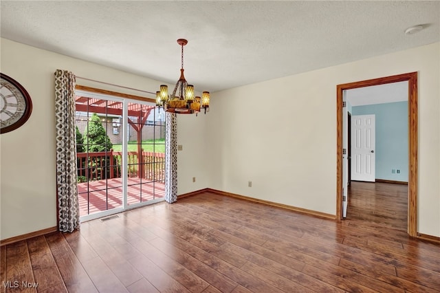 1550 Rebel St SW, Canton, OH 44706 - unfurnished room with a chandelier, wood finished floors, a smoke detector, and a textured ceiling