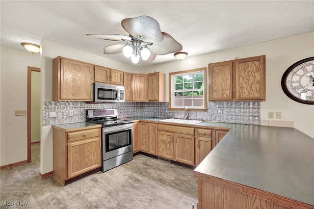 1550 Rebel St SW, Canton, OH 44706 - kitchen featuring appliances with stainless steel finishes, ceiling fan, and decorative backsplash