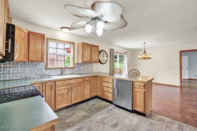 1550 Rebel St SW, Canton, OH 44706 - kitchen featuring fridge, a peninsula, healthy amount of natural light, and a chandelier
