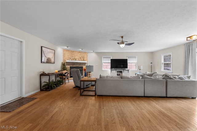 6190 Fitch Rd, North Olmsted, OH 44070 - living area with a fireplace, ceiling fan, and light wood-type flooring