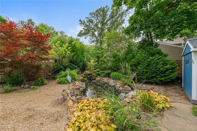 6190 Fitch Rd, North Olmsted, OH 44070 - view of yard featuring a small pond