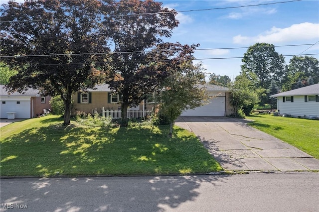 578 25th St NW, Massillon, OH 44647 - obstructed view of property featuring a garage, a front yard, and driveway