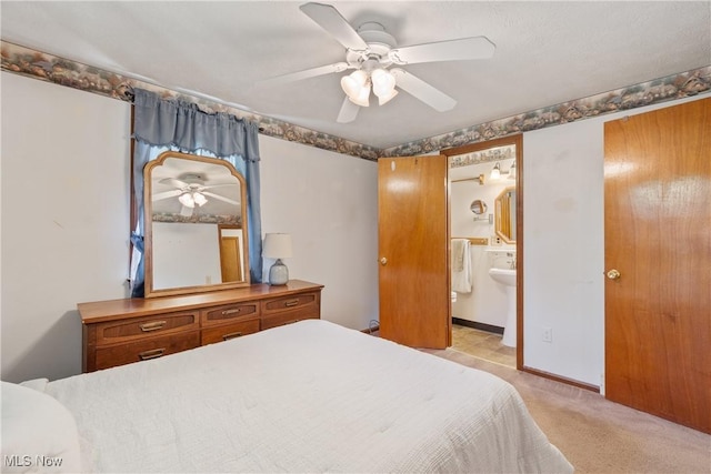 578 25th St NW, Massillon, OH 44647 - bedroom featuring ensuite bathroom, ceiling fan, and light colored carpet