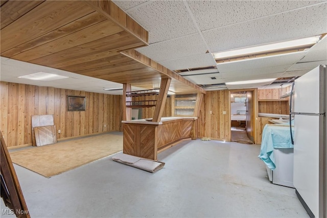 578 25th St NW, Massillon, OH 44647 - finished below grade area featuring freestanding refrigerator, wood walls, and a paneled ceiling