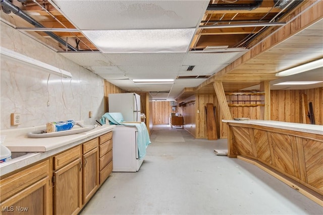 578 25th St NW, Massillon, OH 44647 - finished basement with freestanding refrigerator, wooden walls, washer / dryer, and a drop ceiling