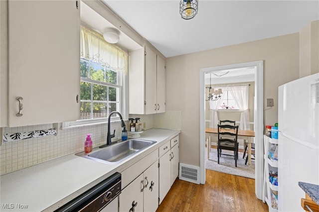 5100 Edenhurst Rd, Lyndhurst, OH 44124 - kitchen with white appliances, tasteful backsplash, healthy amount of natural light, and wood finished floors