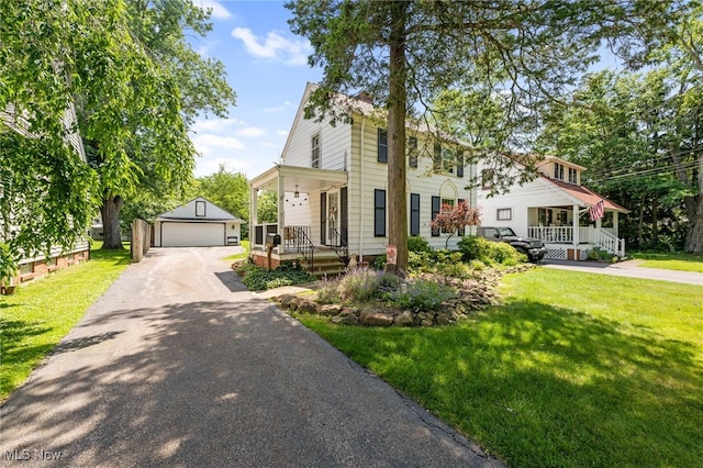 5100 Edenhurst Rd, Lyndhurst, OH 44124 - view of front facade featuring covered porch, an outdoor structure, a front lawn, and a detached garage