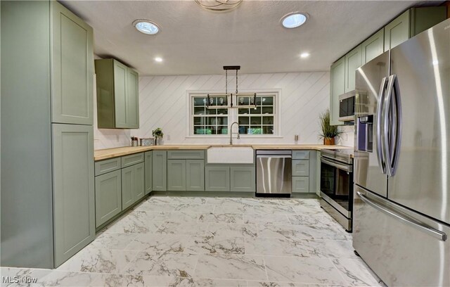 8171 Pheasant Ave NW, North Canton, OH 44720 - kitchen with green cabinets, stainless steel appliances, butcher block countertops, recessed lighting, and light marble finish floors