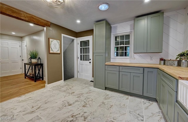 8171 Pheasant Ave NW, North Canton, OH 44720 - kitchen with butcher block counters, gray cabinetry, recessed lighting, and light marble finish floors