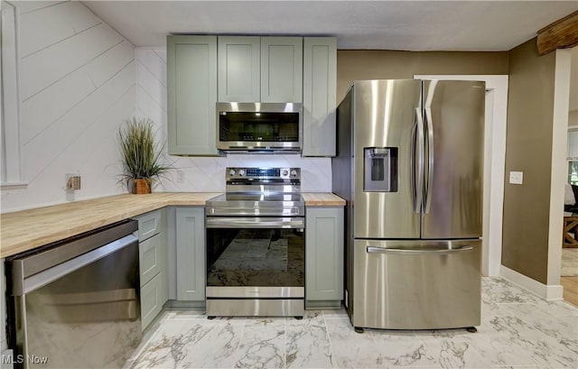 8171 Pheasant Ave NW, North Canton, OH 44720 - kitchen featuring appliances with stainless steel finishes, butcher block counters, gray cabinets, light marble finish flooring, and backsplash