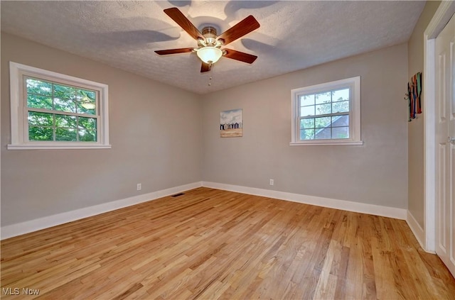 8171 Pheasant Ave NW, North Canton, OH 44720 - spare room featuring light wood-type flooring, a ceiling fan, and a textured ceiling