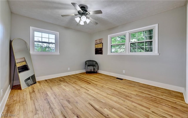 8171 Pheasant Ave NW, North Canton, OH 44720 - unfurnished room with plenty of natural light, light wood finished floors, and ceiling fan