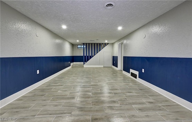 8171 Pheasant Ave NW, North Canton, OH 44720 - finished basement with a textured wall, a textured ceiling, and recessed lighting