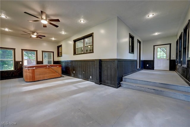 8171 Pheasant Ave NW, North Canton, OH 44720 - interior space featuring wainscoting, finished concrete flooring, a ceiling fan, healthy amount of natural light, and recessed lighting