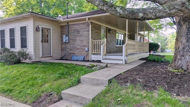8171 Pheasant Ave NW, North Canton, OH 44720 - view of front of house with covered porch, brick siding, and a front yard
