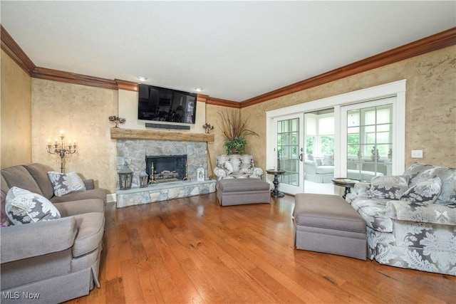 8309 Gentry St NW, Massillon, OH 44646 - living room with hardwood / wood-style flooring, crown molding, and a stone fireplace