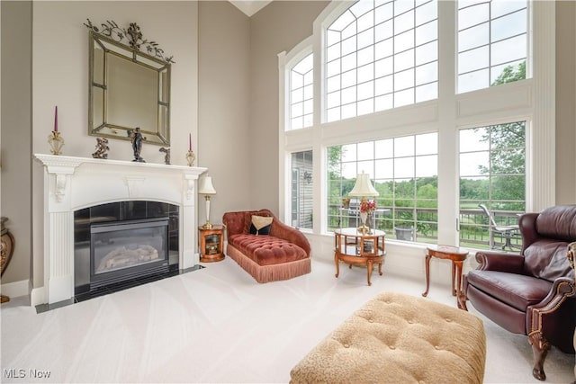 8309 Gentry St NW, Massillon, OH 44646 - living area with healthy amount of natural light, a fireplace, a towering ceiling, and carpet flooring