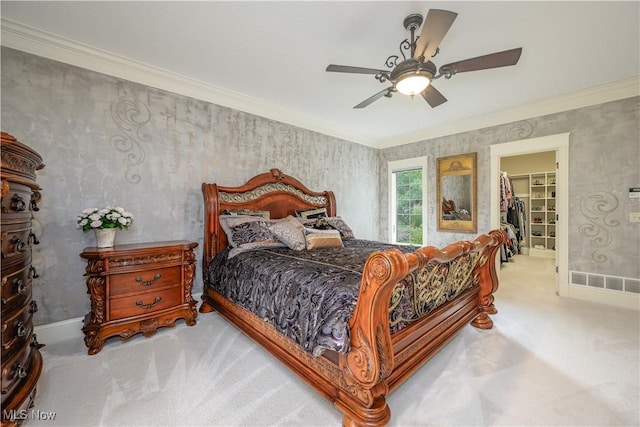 8309 Gentry St NW, Massillon, OH 44646 - bedroom with carpet, a walk in closet, ornamental molding, ceiling fan, and wallpapered walls
