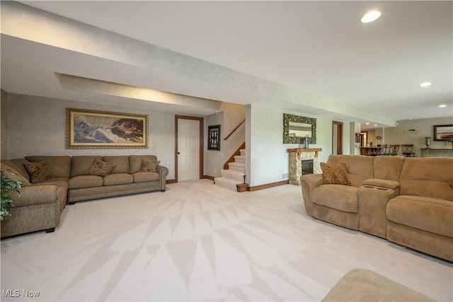 8309 Gentry St NW, Massillon, OH 44646 - living room featuring light carpet, a stone fireplace, stairway, and recessed lighting