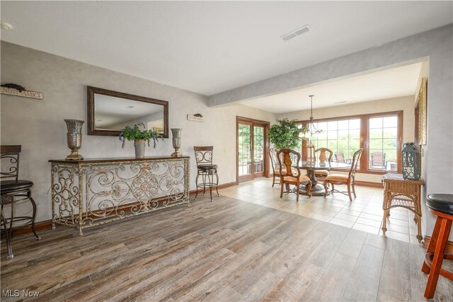 8309 Gentry St NW, Massillon, OH 44646 - dining room with wood finished floors and a chandelier