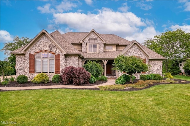 8309 Gentry St NW, Massillon, OH 44646 - view of front facade with stone siding, a front lawn, and roof with shingles