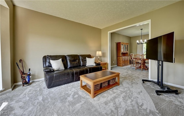 2720 Pinegate Dr, Norton, OH 44203 - carpeted living area featuring a chandelier and a textured ceiling