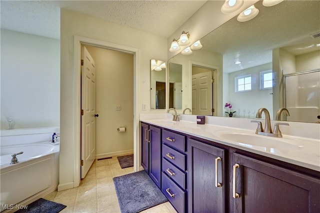 2720 Pinegate Dr, Norton, OH 44203 - bathroom featuring a bath, double vanity, a stall shower, tile patterned flooring, and a textured ceiling
