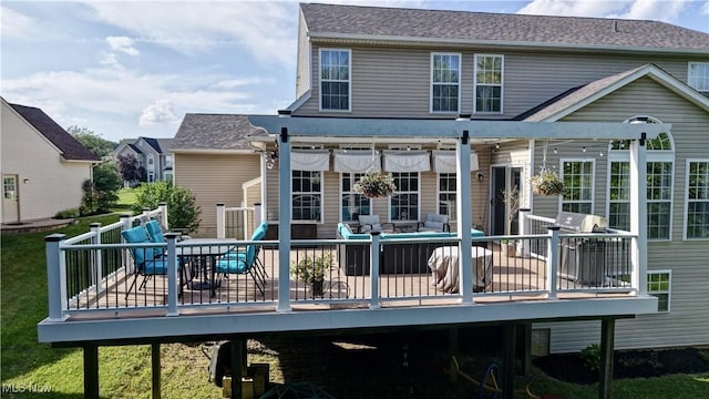 2720 Pinegate Dr, Norton, OH 44203 - back of property with a deck, outdoor dining area, and a shingled roof