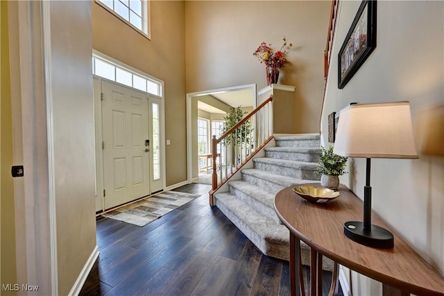 2720 Pinegate Dr, Norton, OH 44203 - entrance foyer with a high ceiling, dark wood-style flooring, and stairway