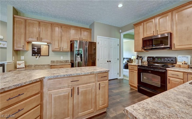 2720 Pinegate Dr, Norton, OH 44203 - kitchen with stainless steel microwave, refrigerator with ice dispenser, black range with electric cooktop, light brown cabinets, and light countertops
