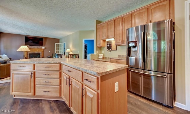 2720 Pinegate Dr, Norton, OH 44203 - kitchen featuring stainless steel fridge, light brown cabinets, open floor plan, dark wood-style floors, and a textured ceiling