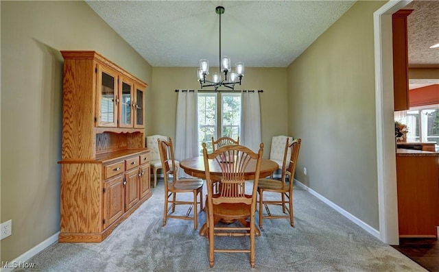 2720 Pinegate Dr, Norton, OH 44203 - dining room with a chandelier, a textured ceiling, plenty of natural light, and light colored carpet