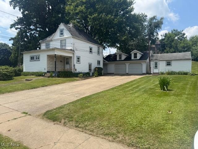 2425 Maple Ave NE, Canton, OH 44714 - traditional style home with concrete driveway, a front lawn, and an attached garage