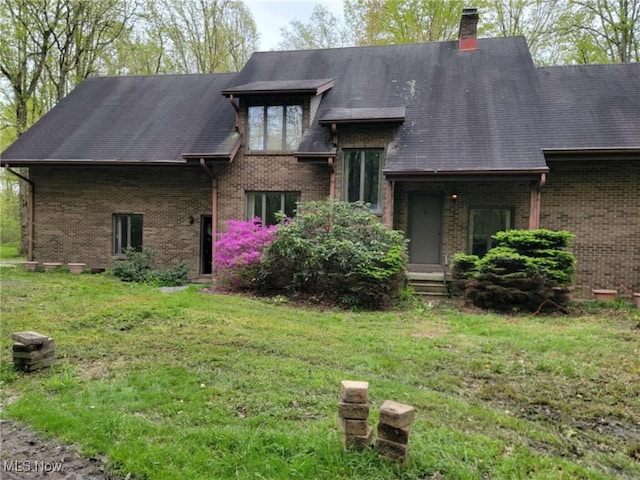 5450 King Graves Rd, Vienna, OH 44473 - back of property with brick siding, a yard, a chimney, and roof with shingles