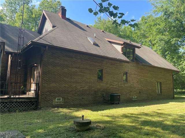 5450 King Graves Rd, Vienna, OH 44473 - view of side of home with brick siding, a lawn, a chimney, and a shingled roof