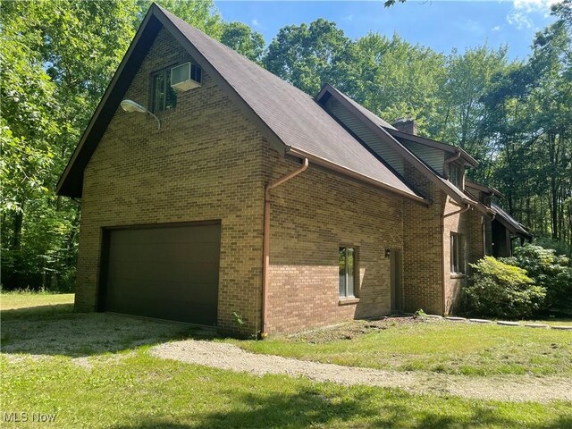 5450 King Graves Rd, Vienna, OH 44473 - view of home's exterior with a lawn and brick siding