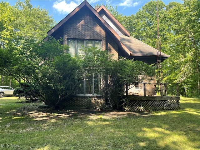 5450 King Graves Rd, Vienna, OH 44473 - view of side of home with a lawn, brick siding, and a deck