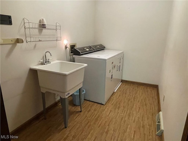 5450 King Graves Rd, Vienna, OH 44473 - laundry room featuring light wood-style floors and washing machine and clothes dryer