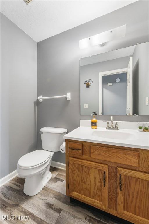 1234 W Maple St, North Canton, OH 44720 - half bath featuring vanity and wood finished floors