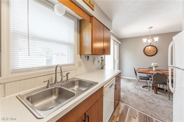 1234 W Maple St, North Canton, OH 44720 - kitchen with white appliances, brown cabinetry, plenty of natural light, and light countertops